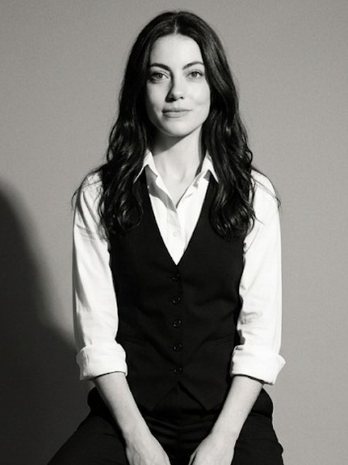 Portrait of Mariana Peterossi, seated, in a black waistcoat and white shirt